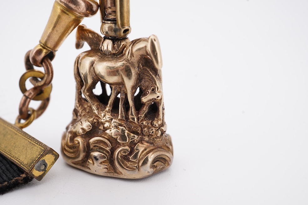A late Victorian yellow metal overlaid and citrine set watch key fob, depicting two horses and two rams?, 30mm on a black sash suspension, together with a modern pair of 9ct gold and cultured pearl set leaf ear studs. Co